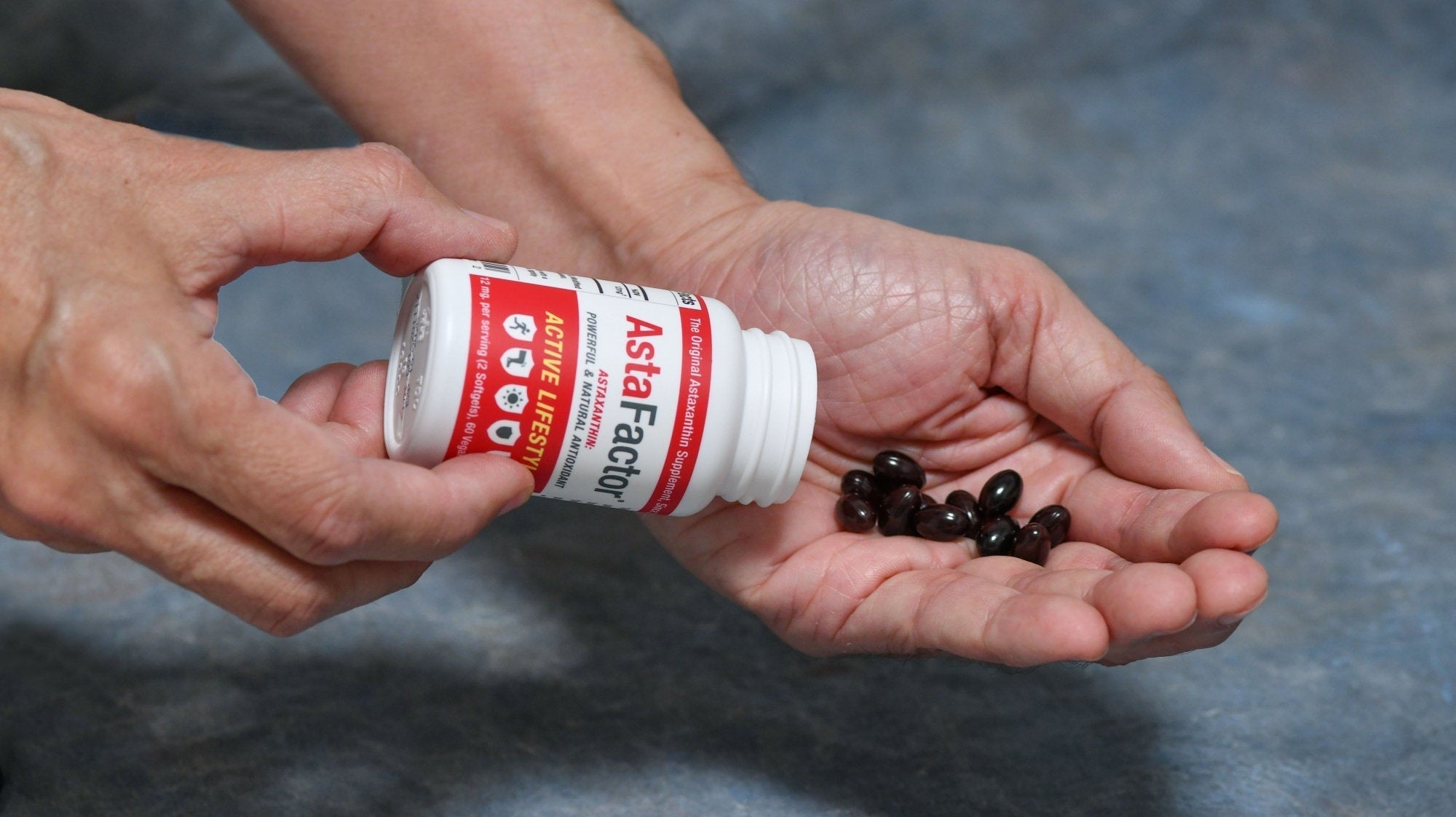 Astaxanthin Bottle and Hand