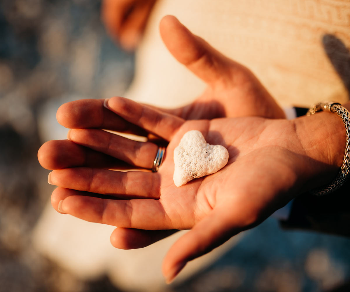 Hands Holding Heart Shaped Coral