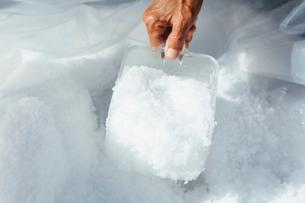 Salt being scooped from hopper