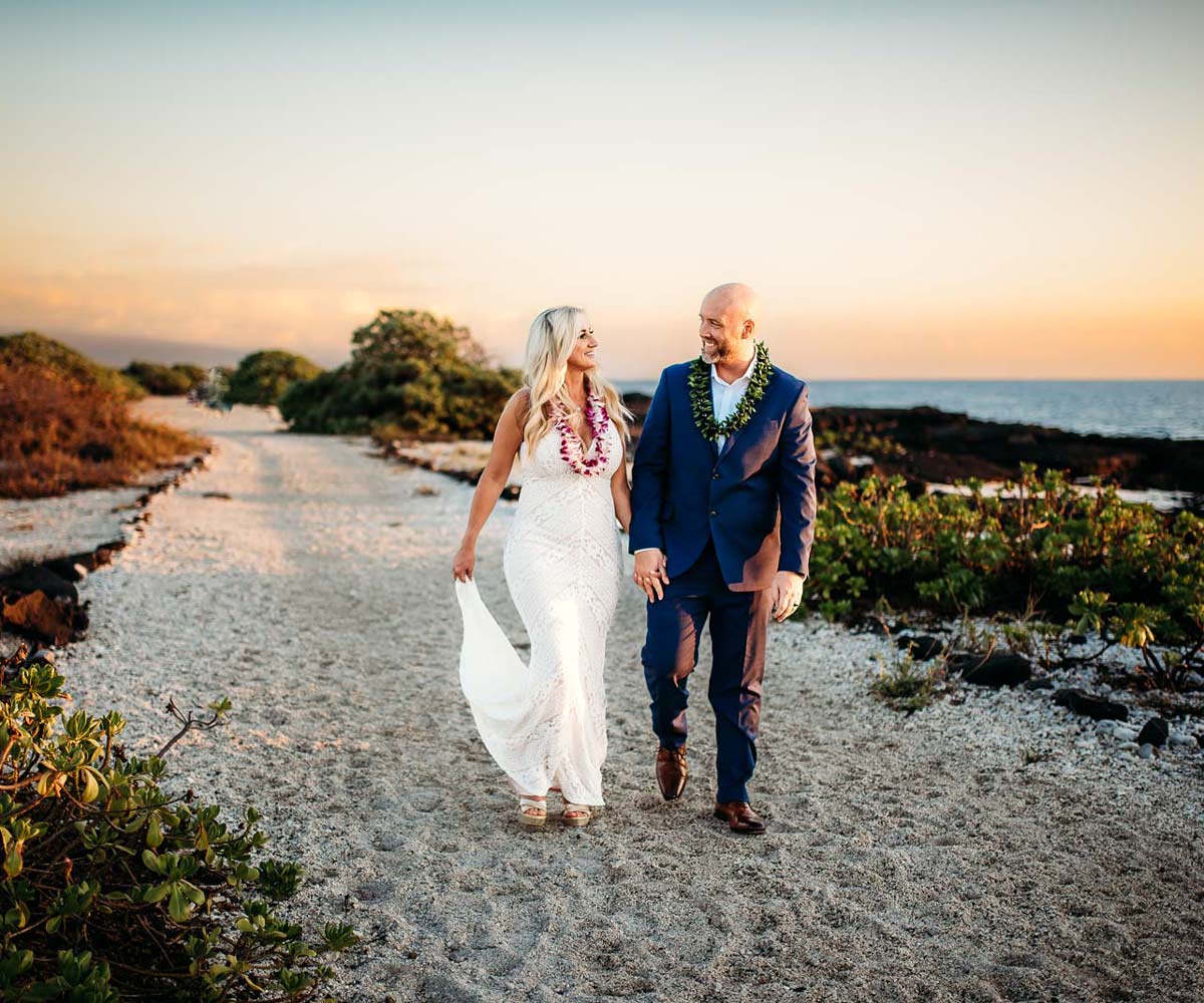 Wedding Couple Walking in Sand at Sunset