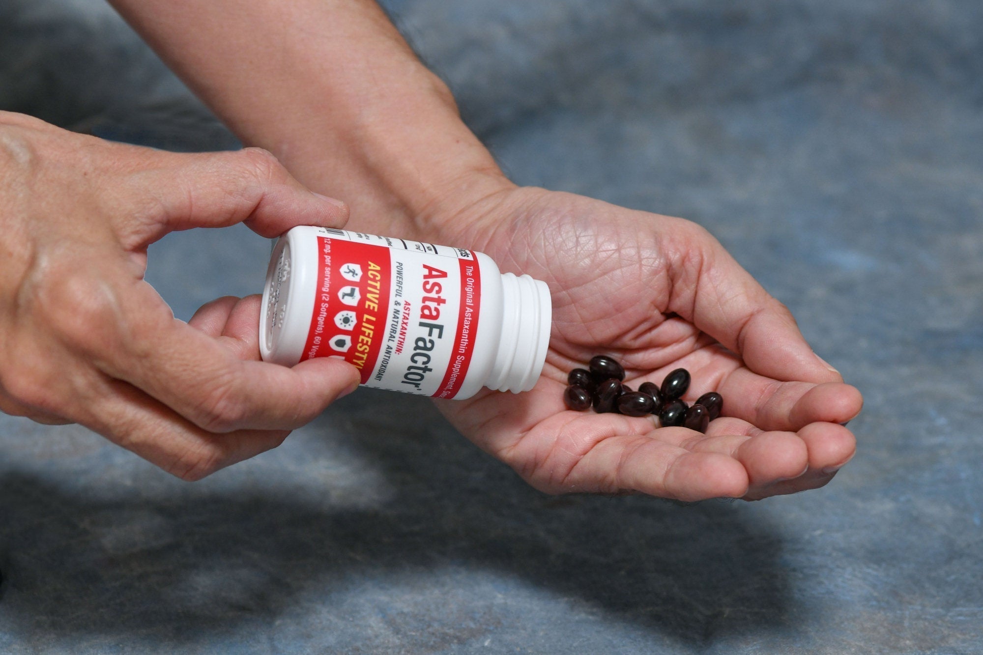 Astaxanthin Bottle and Hand