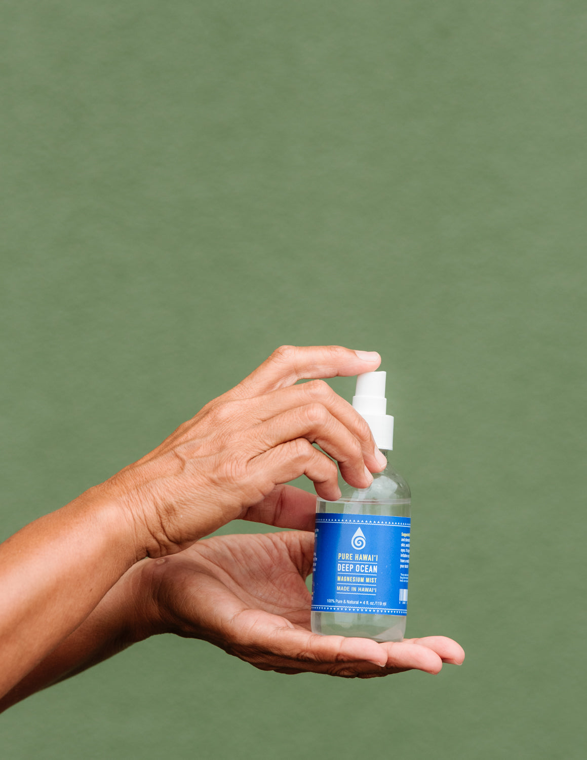 Woman's hands holding Magnesium Spray 