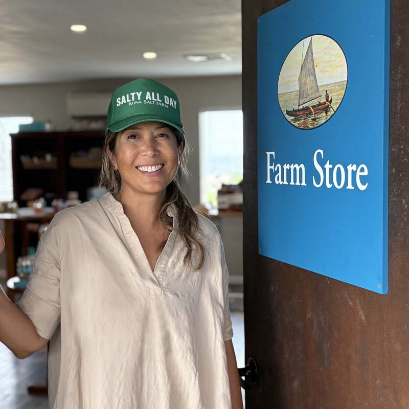 Salt Farm door sign with employee wearing a logo hat