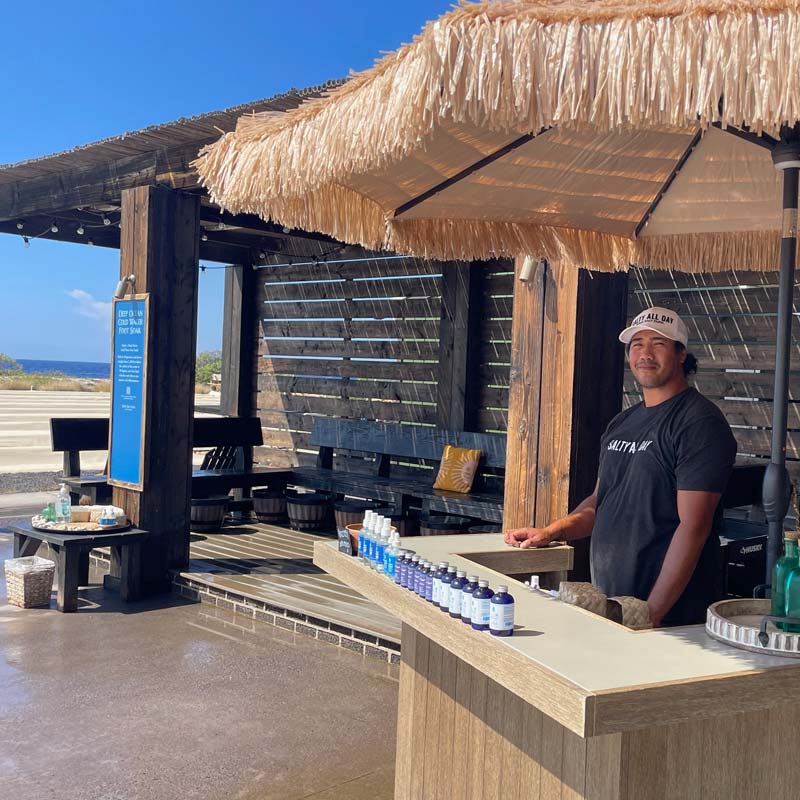 Attendant standing behind check-in counter at the Foot Soak station.