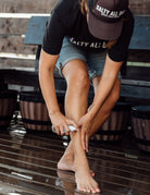 Woman sparying Magnesium Mist on her legs